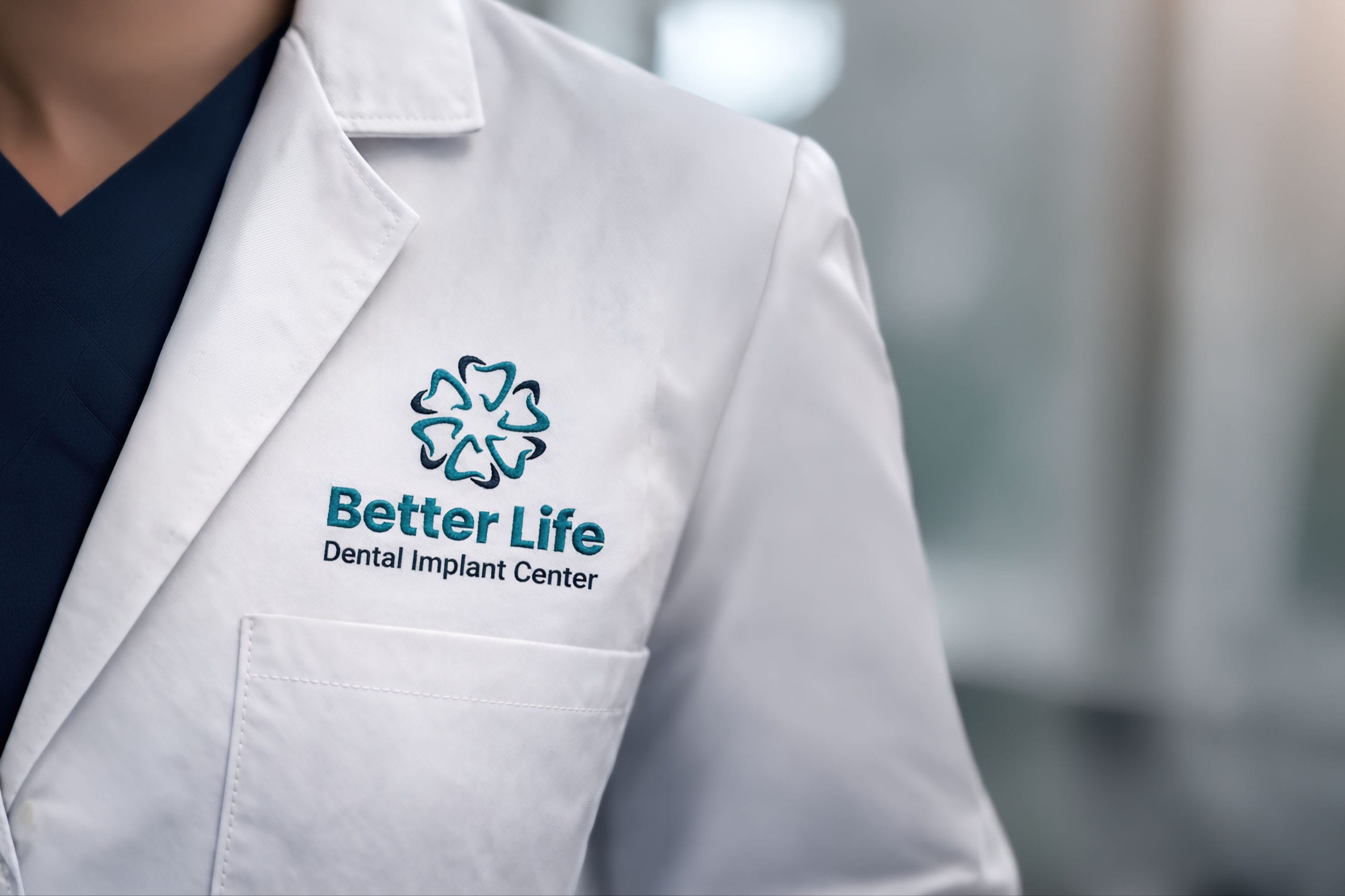 A dentist's coat with the logo of Better Life Dental Implant Center
