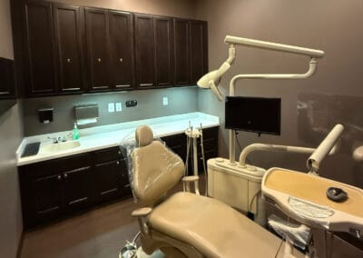 Modern dental treatment room at Better Life Dental Implant Center with chair, exam light, and equipment